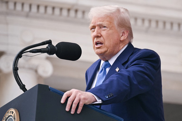 Donald Trump speaks at a podium.