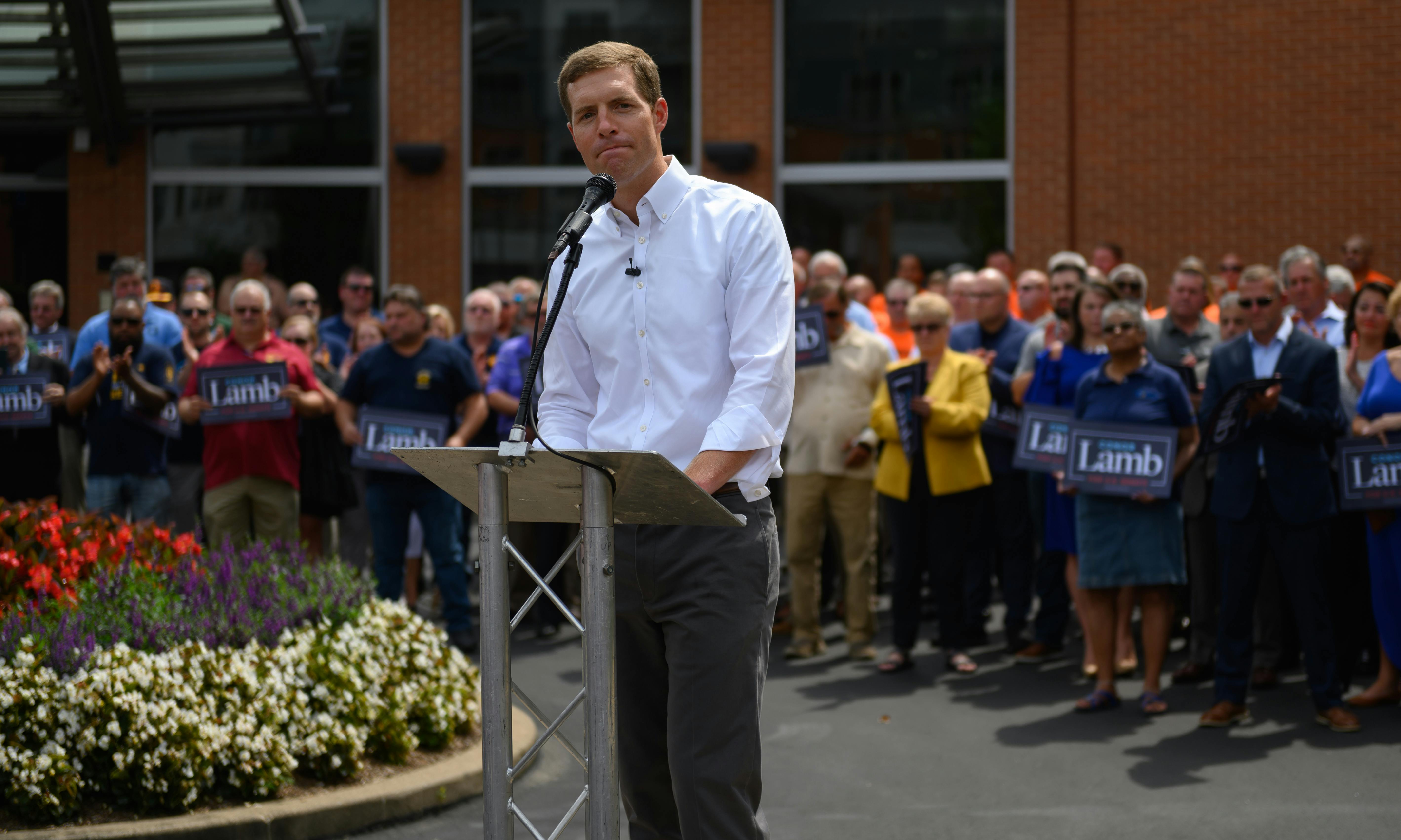 Conor Lamb stands behind a lectern as he speaks to a crowd in the Pittsburgh.