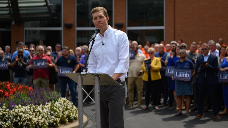 Conor Lamb stands behind a lectern as he speaks to a crowd in the Pittsburgh.