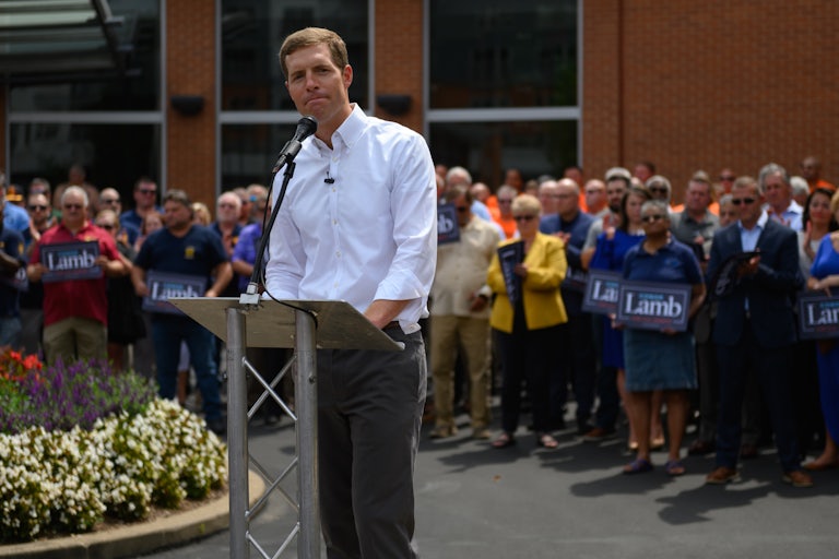 Conor Lamb stands behind a lectern as he speaks to a crowd in the Pittsburgh.