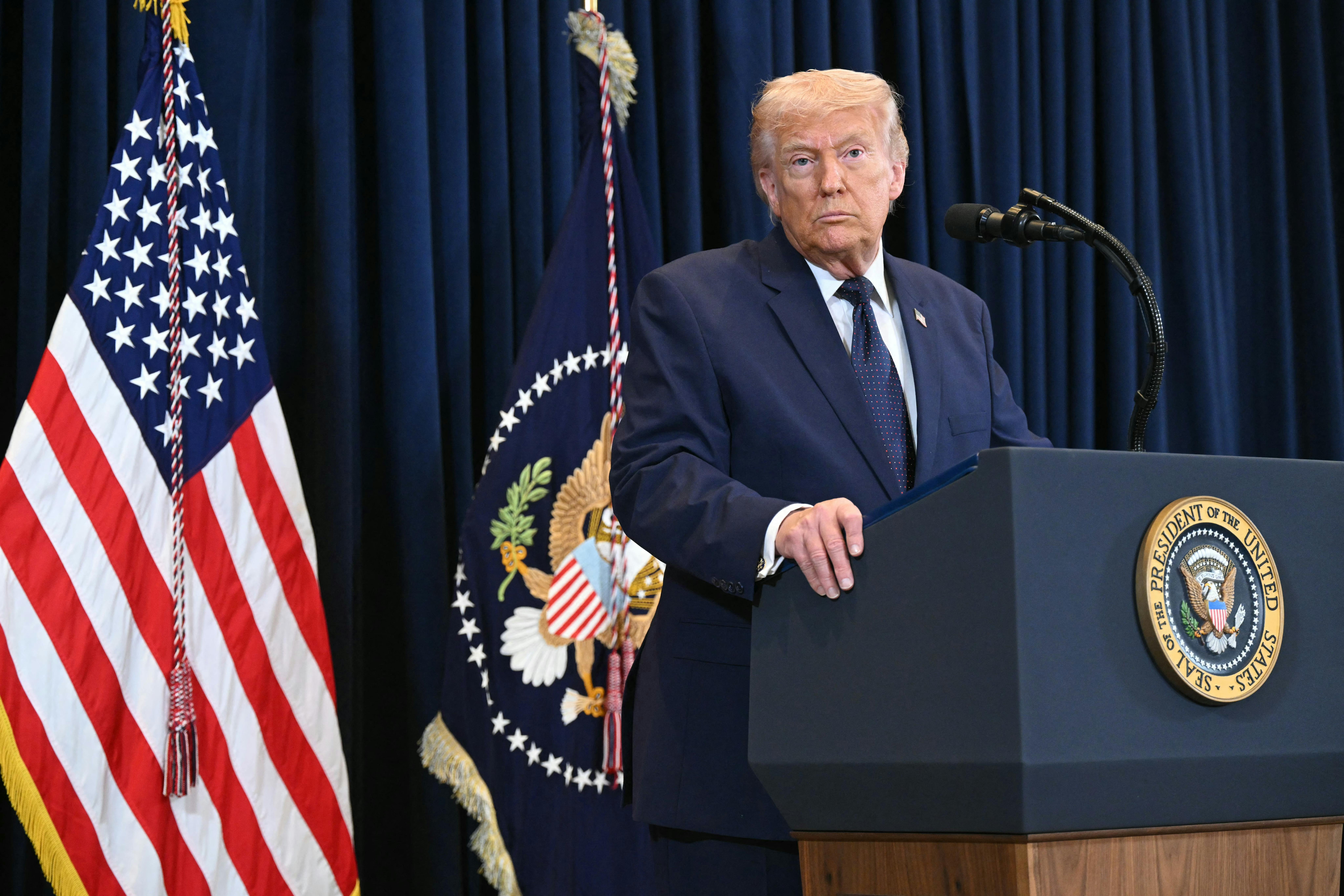 President Donald Trump stands at a podium