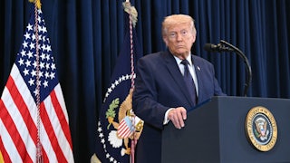 President Donald Trump stands at a podium