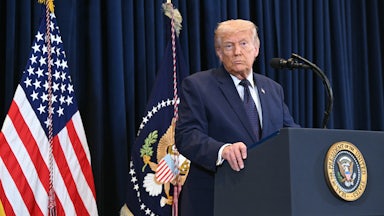 President Donald Trump stands at a podium