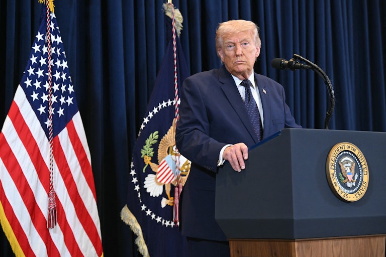 President Donald Trump stands at a podium