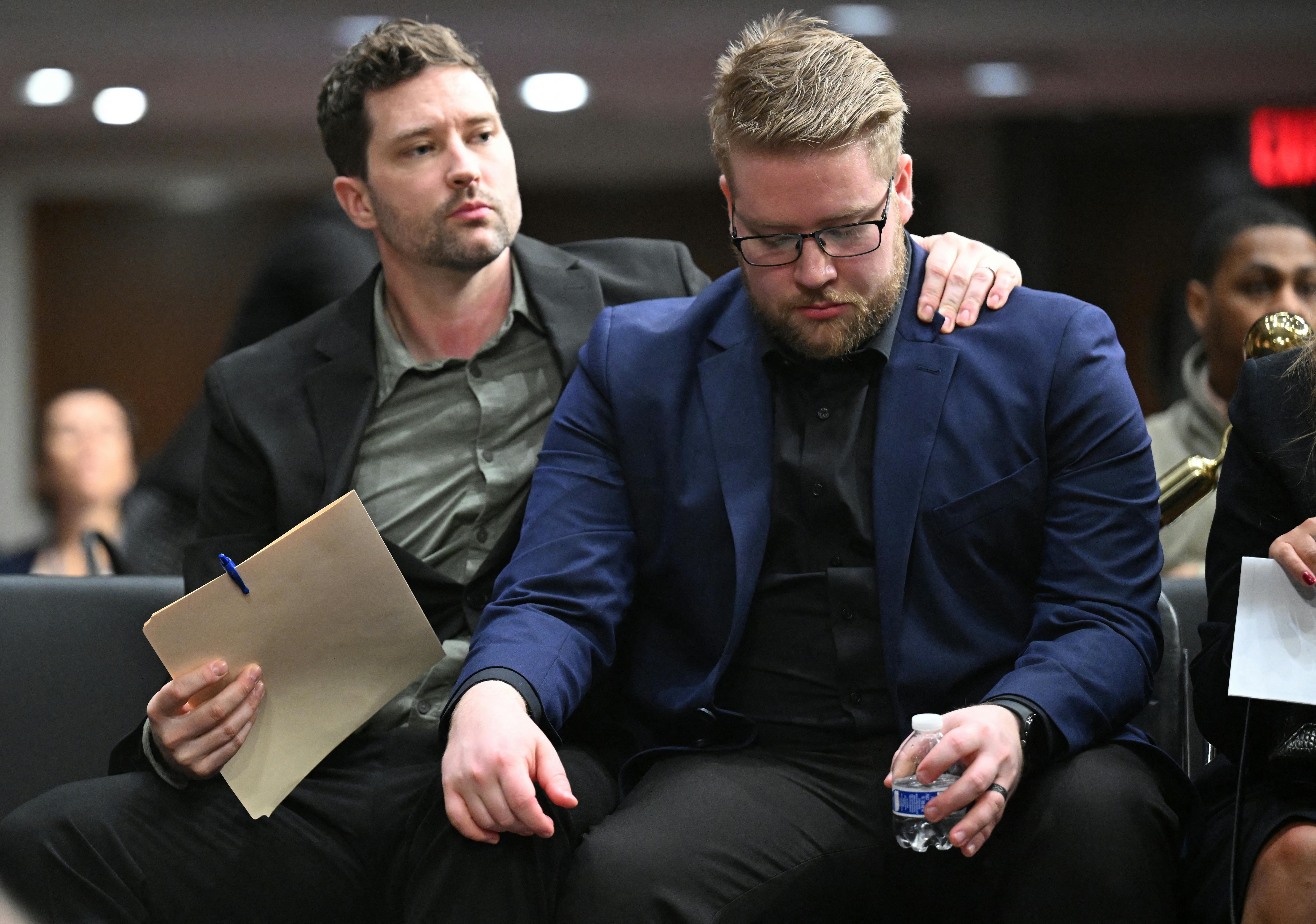 Brent Ganger puts his arm around his brother Luke Ganger after they testified in Congress about the death of their sister Renee Nicole Good