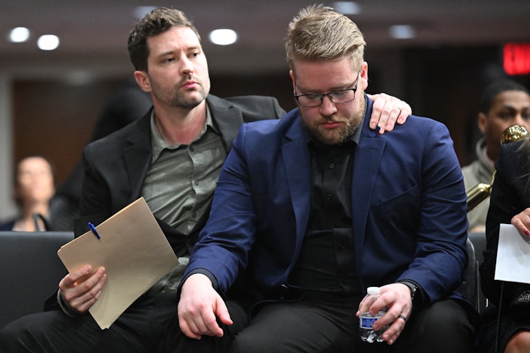 Brent Ganger puts his arm around his brother Luke Ganger after they testified in Congress about the death of their sister Renee Nicole Good