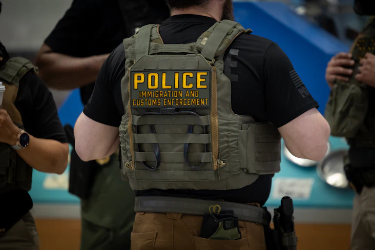ICE agents stand in an airport