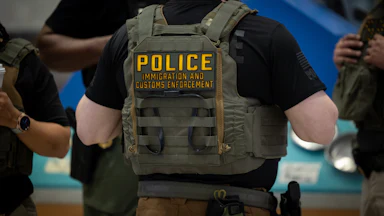 ICE agents stand in an airport