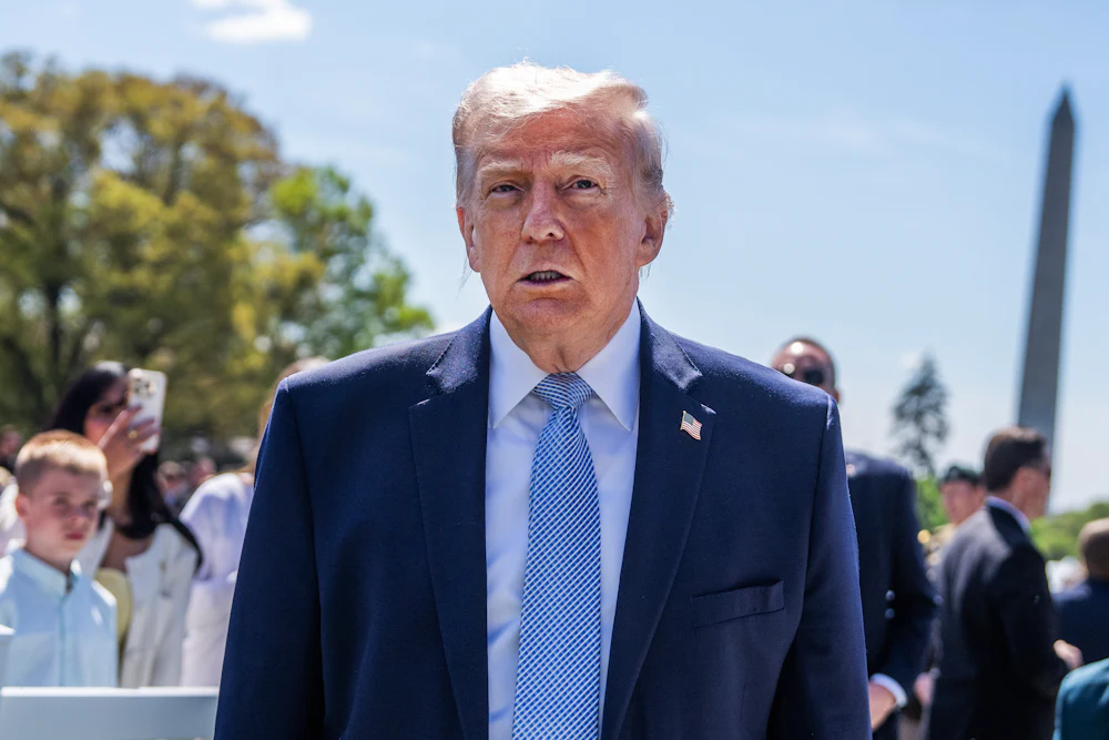 Donald Trump stands outside the White House during the Easter egg roll