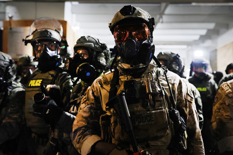 Masked ICE agents stand next to each other