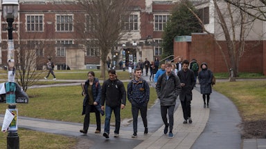 Students walk on a path outside on Princeton University campus.