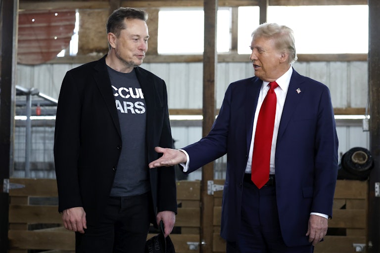 Donald Trump offers his hand to Elon Musk back stage during a campaign rally in Butler, Pennsylvania.