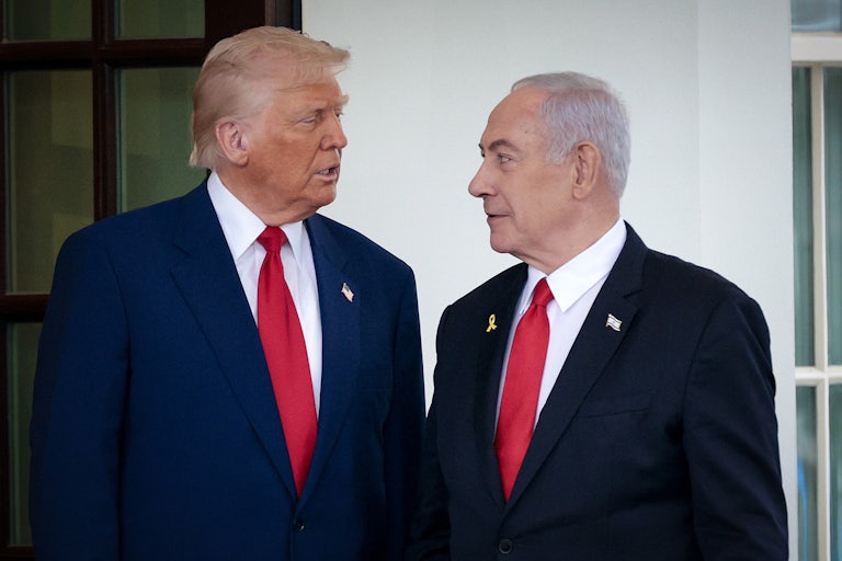 Donald Trump and Israeli Prime Minister Benjamin Netanyahu look at each other while standing outside the White House