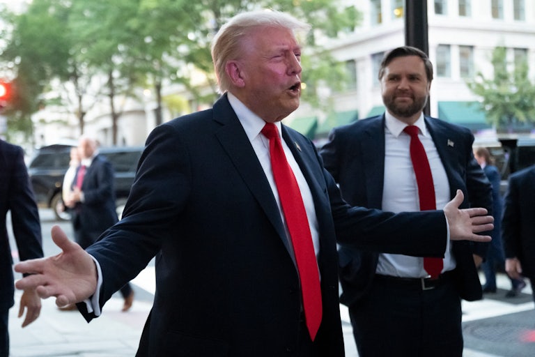 Donald Trump holds his hands out to the side while speaking outside a restaurant in Washington, D.C.