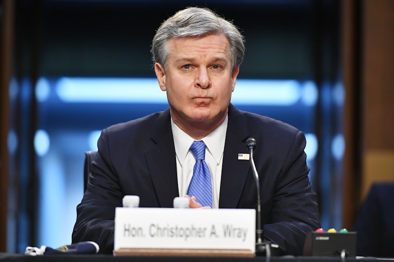 Christopher Wray purses his lips while testifying during a Senate Judiciary Committee hearing