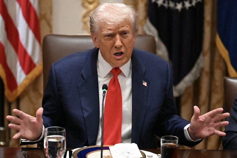 Donald Trump gestures with both hands while speaking