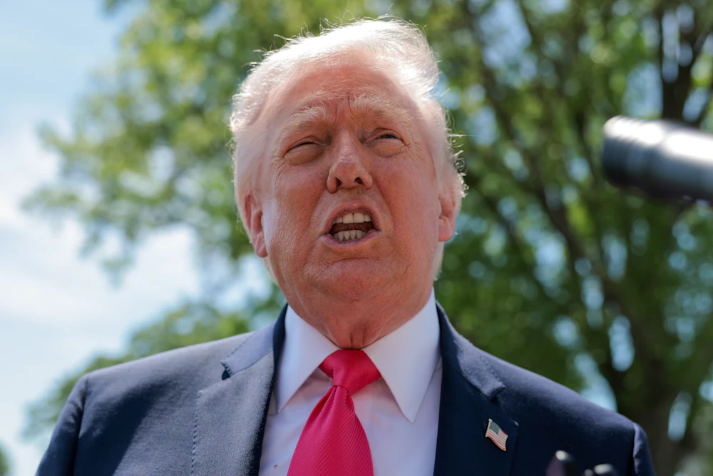 Donald Trump speaks to the media before boarding Marine One on the South Lawn of the White House.