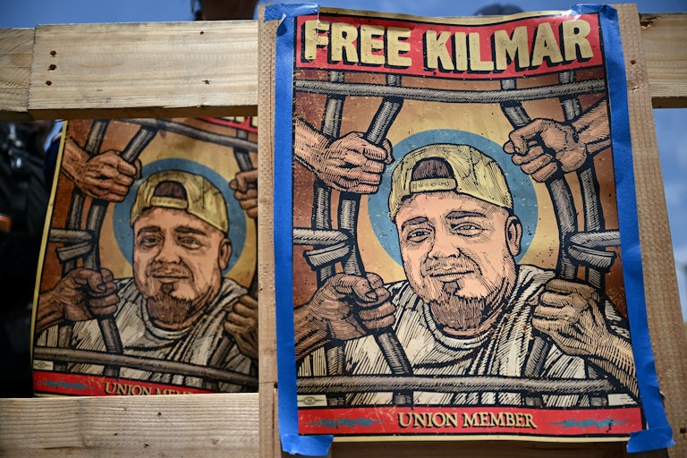 People hold up posters calling for the return of Kilmar Abrego Garcia at a protest in support of union workers