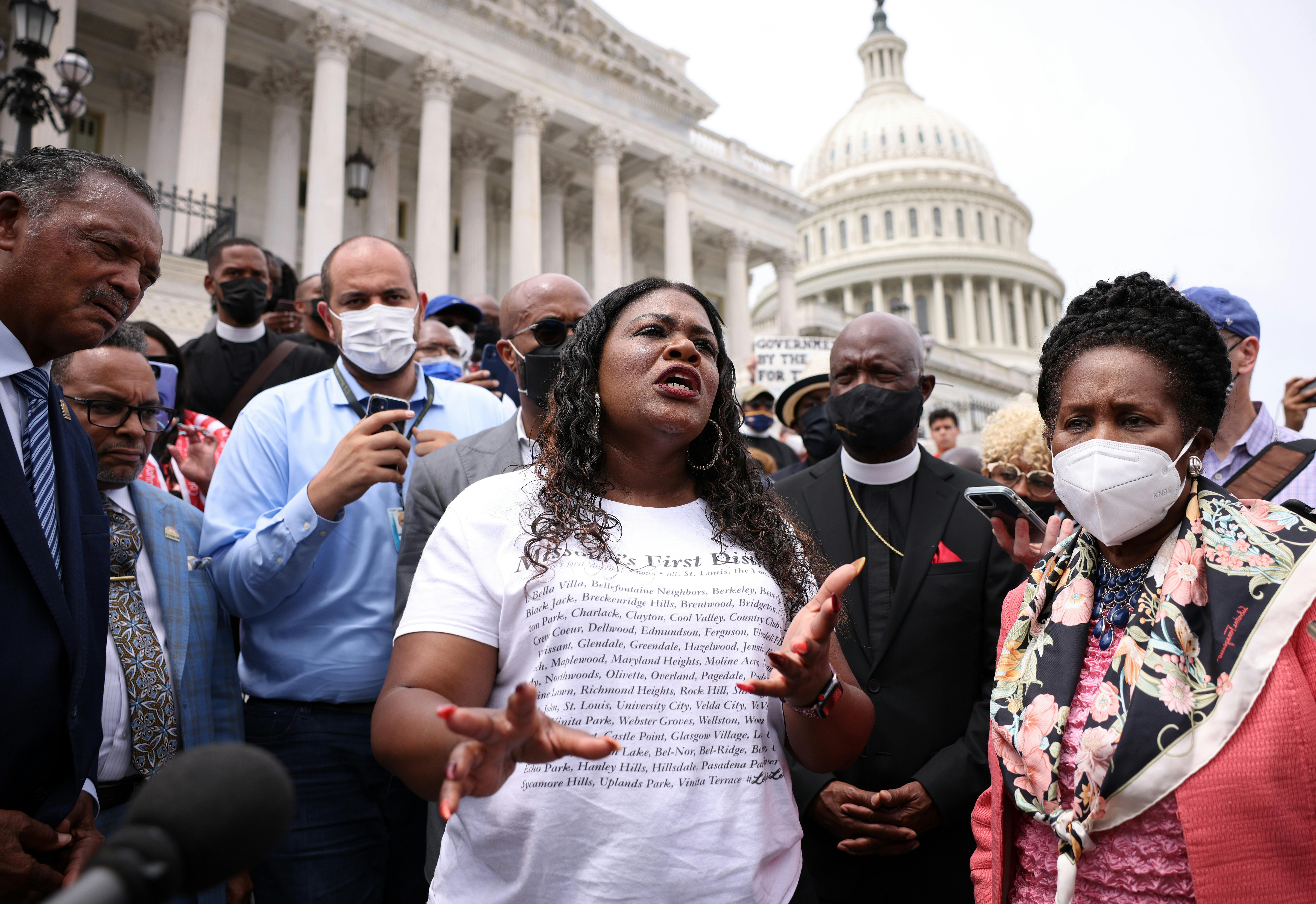 Cori Bush speaks before a large crowd on the steps of the Capitol.
