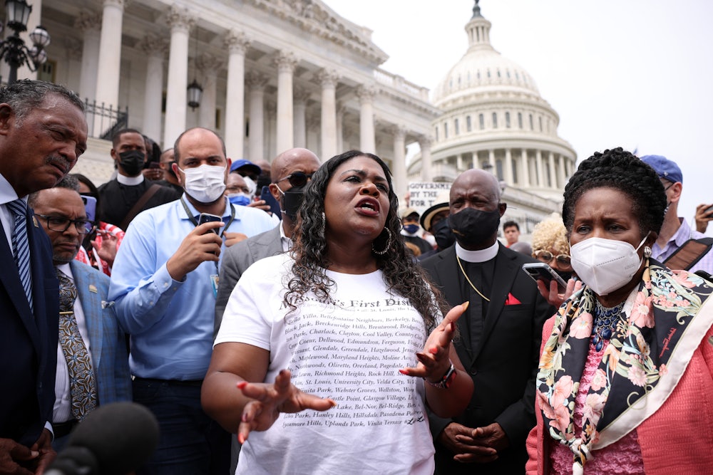Cori Bush speaks before a large crowd on the steps of the Capitol.
