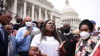 Cori Bush speaks before a large crowd on the steps of the Capitol.