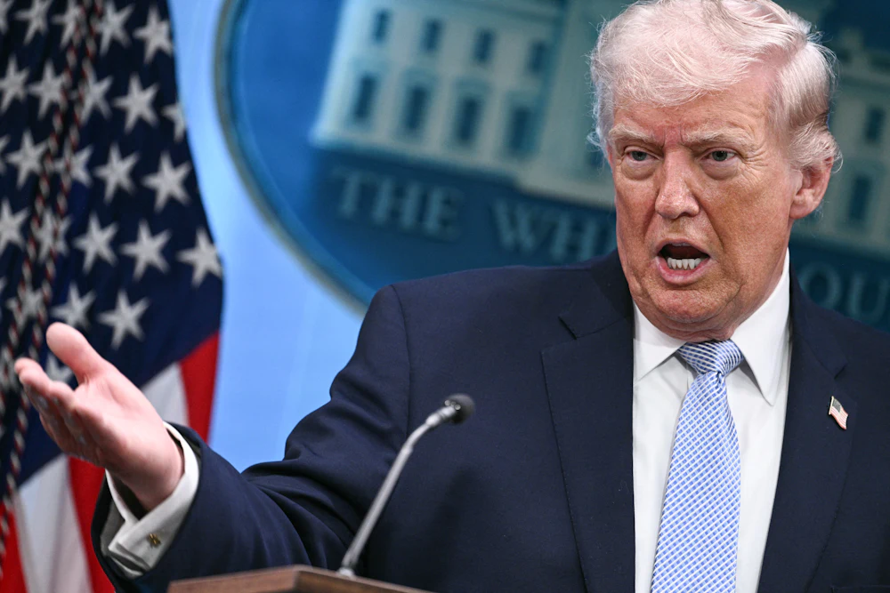 Donald Trump gestures with right hand while standing and speaking
