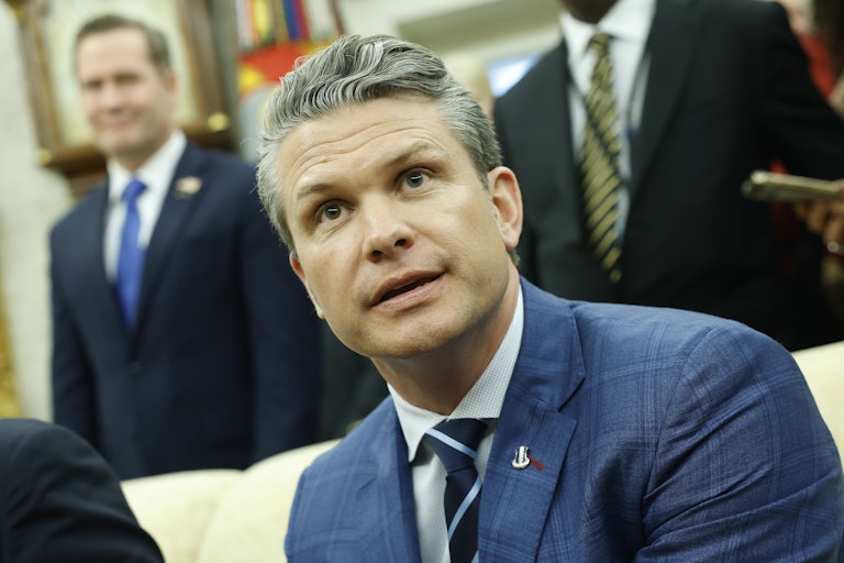 Pete Hegseth sits in the Oval Office