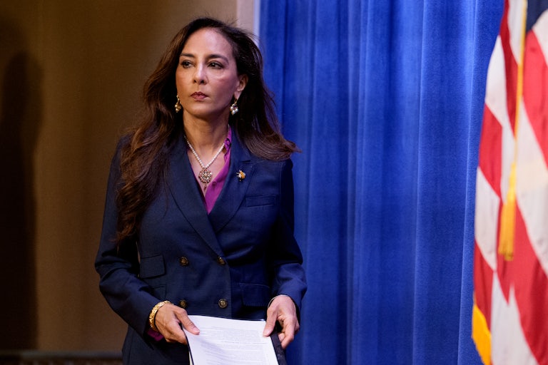 Assistant Attorney General for Civil Rights Harmeet Dhillon walks out with a piece of paper in her hands.