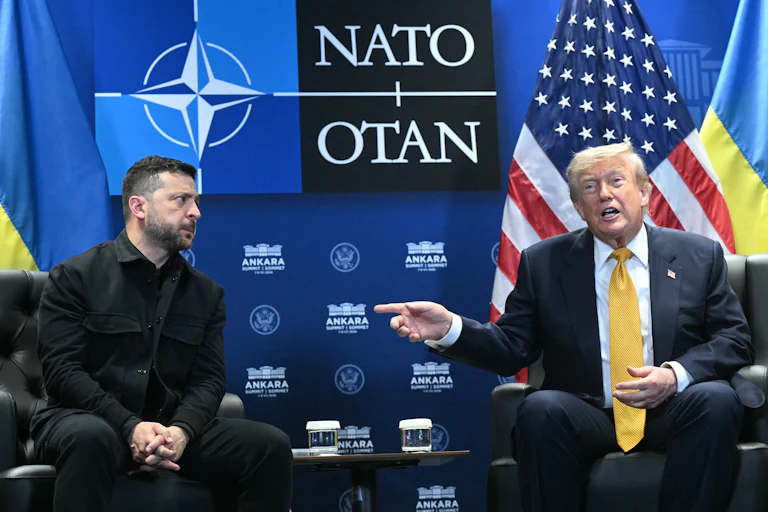 Ukraine’s President Volodymyr Zelenskiy looks on concerned as Donald Trump speaks and points at him.