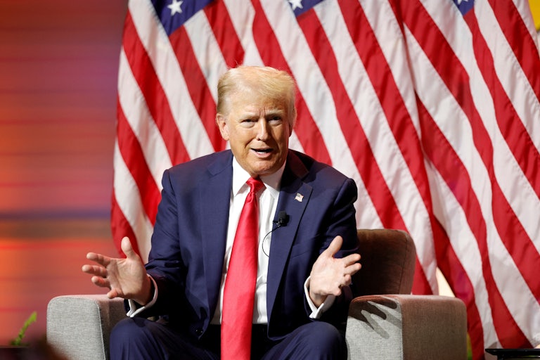 Donald Trump speaks at NABJ, makes a weird face, and splays his hands out.