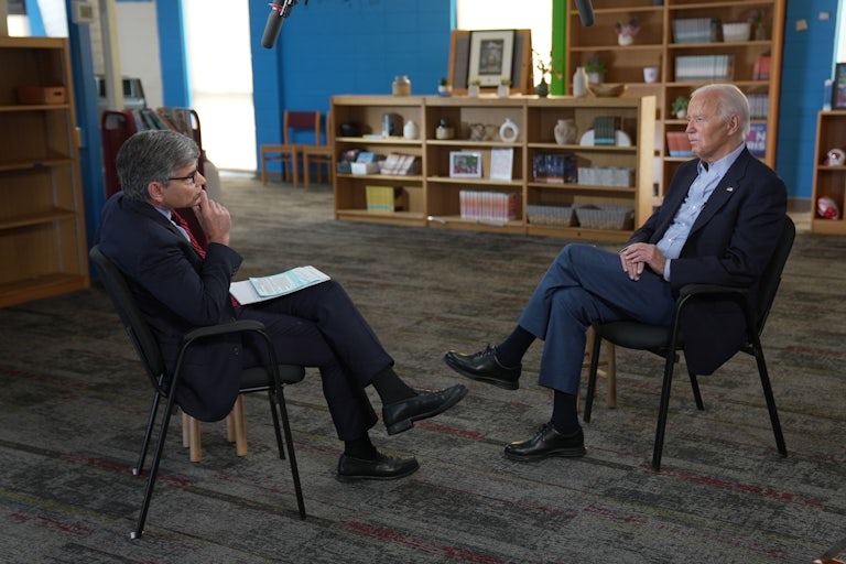 George Stephanopoulos and Joe Biden sit facing each other