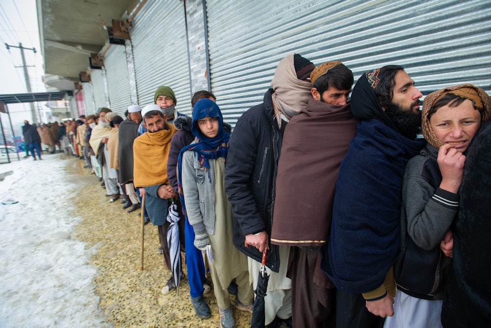 Afghans line up for a monthly food ration from the UN World Food Program.