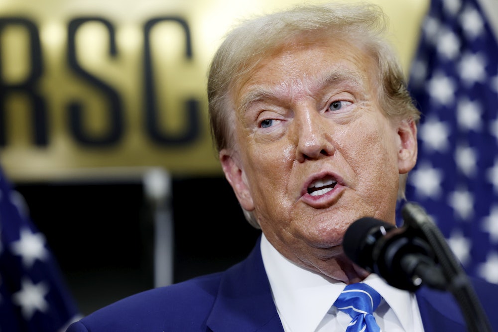 Former President Donald Trump is seen delivering vehement remarks into a microphone at a meeting with congressional Republicans.
