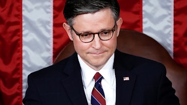 Mike Johnson looks slightly down