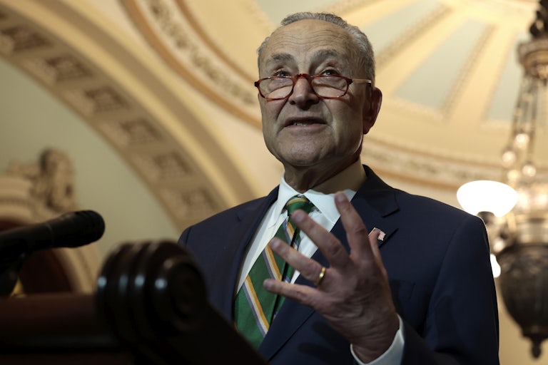 Chuck Schumer gestures during a press conference.
