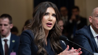 Homeland Security Secretary speaks into a microphone while sitting in a House committee hearing