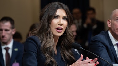 Homeland Security Secretary speaks into a microphone while sitting in a House committee hearing