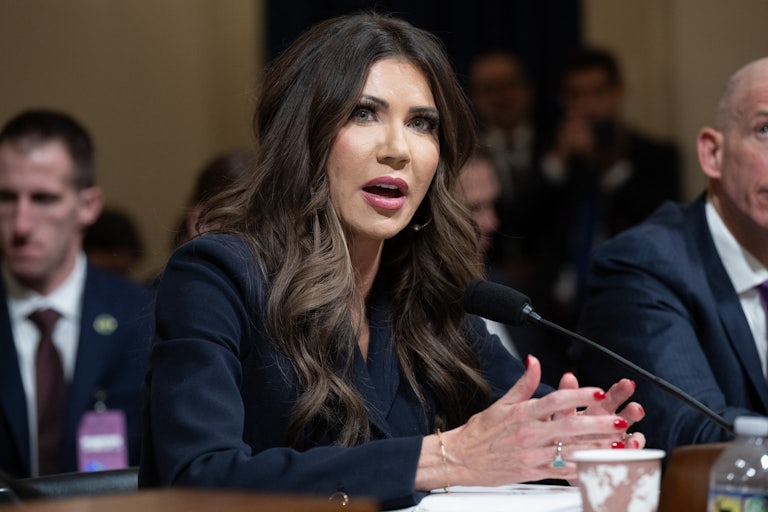 Homeland Security Secretary speaks into a microphone while sitting in a House committee hearing