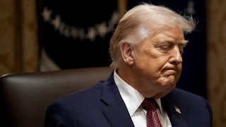 Donald Trump frowns while sitting in the White House Cabinet Room