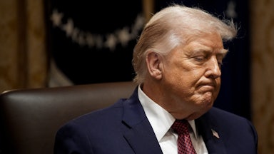 Donald Trump frowns while sitting in the White House Cabinet Room