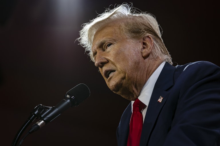 Donald Trump speaking at a mic