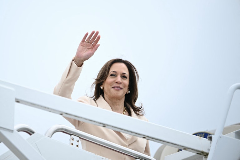 Kamala Harris waves before boarding the Air Force Two plane