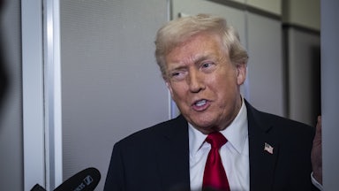 Donald Trump speaks to reporters aboard Air Force One.