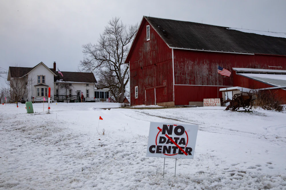 A sign on a rural Michigan road opposes a planned $7 billion data center on southeast Michigan farm land. Opponents say the Data Center could raise residential electricity rates and endanger the water supply.