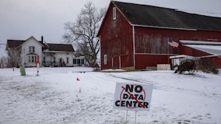 A sign on a rural Michigan road opposes a planned $7 billion data center on southeast Michigan farm land. Opponents say the Data Center could raise residential electricity rates and endanger the water supply.