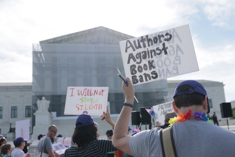 People protest against restrictions on access to LGBTQ books outside the Supreme Court in Washington, D.C.