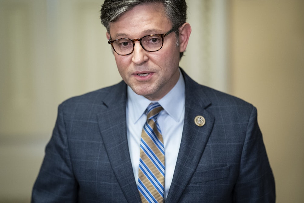 Mike Johnson opens his mouth to speak.