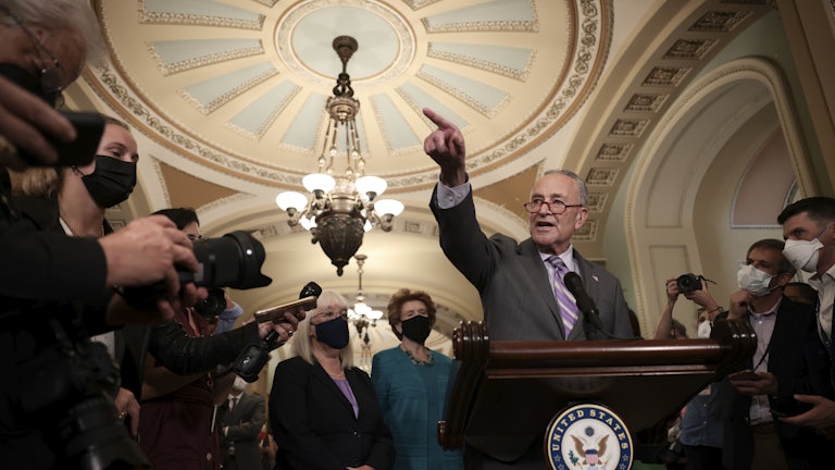 Senate Majority Leader Charles Schumer points as he speaks to reporters at the U.S. Capitol.