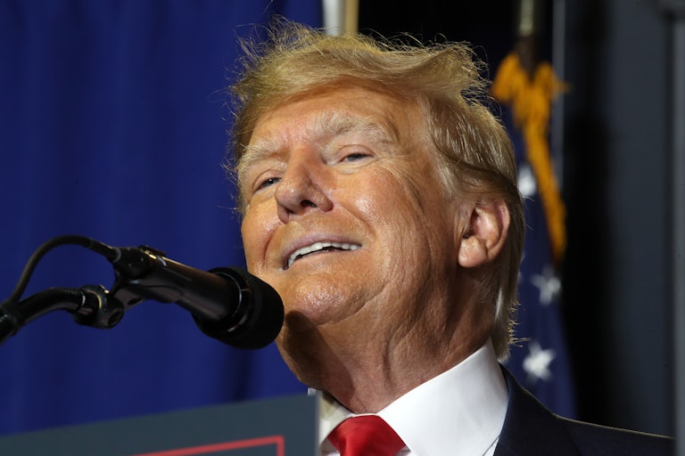 Donald Trump speaks with a mic in front of him