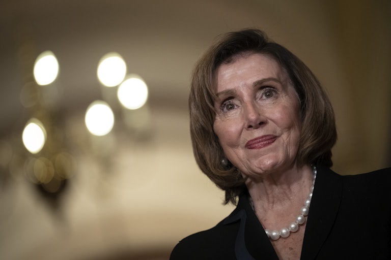 Nancy Pelosi smiles.